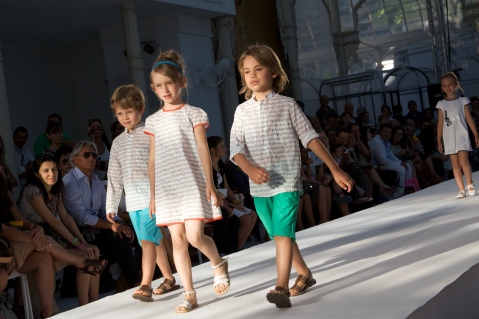Musical scores and emblems decorated girls dresses and boys shirts at Fendi for summer 2012
